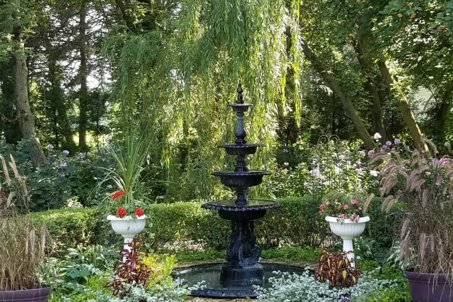 A fountain in the garden area at the lush gardens at the Hollyhock House & Gardens in Kewaunee, WI