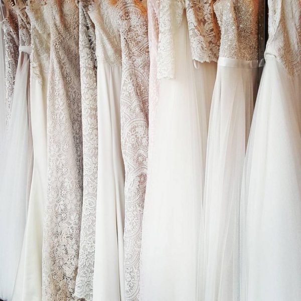 A row of elegant bridal gowns at Erika's Bridal Couture in Neenah