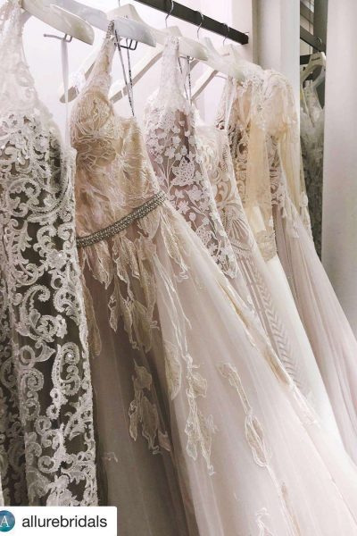 Elegant wedding gowns on rack.