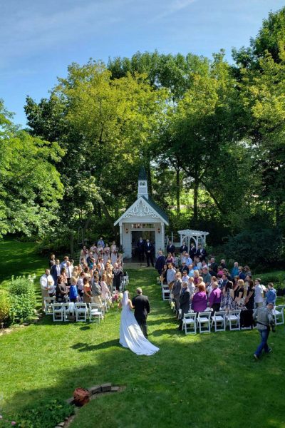 Outdoor garden wedding ceremony at the Hollyhock House & Gardens in Kewaunee, WI