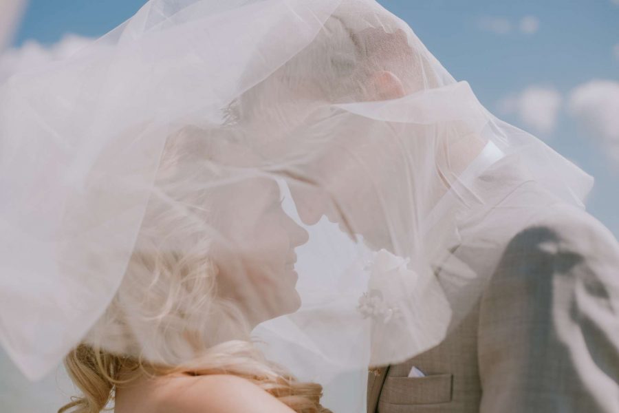 Bride looks up at groom under her veil-Anna Gutermuth Photography
