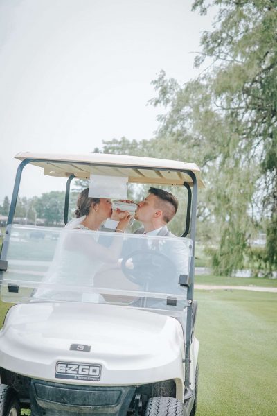 Hailey & Tanner share a drink in a golf cart