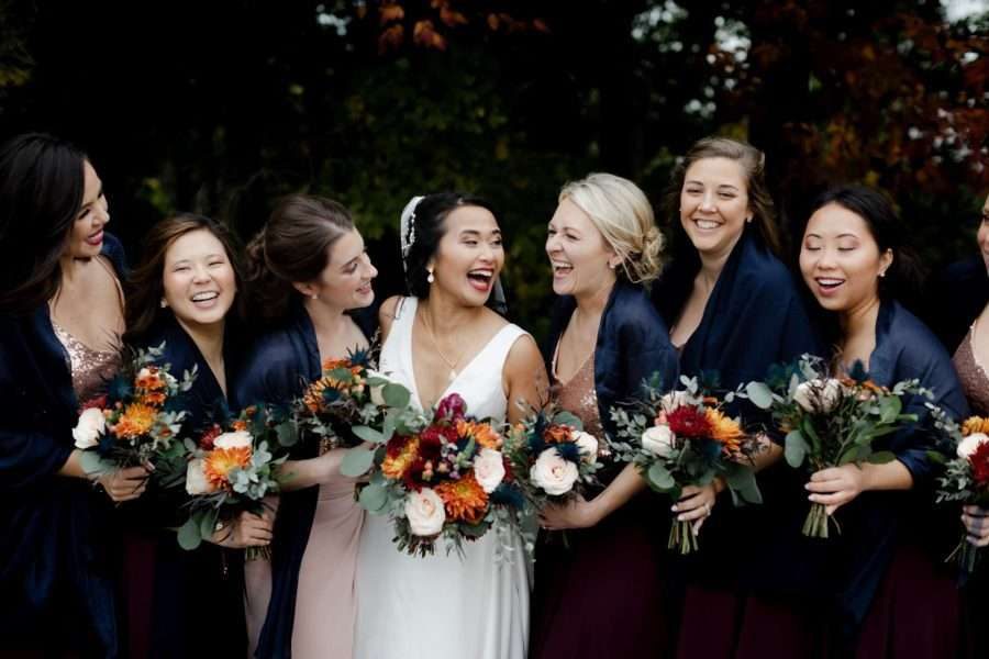 Bride and her bridesmaids with bouquets.