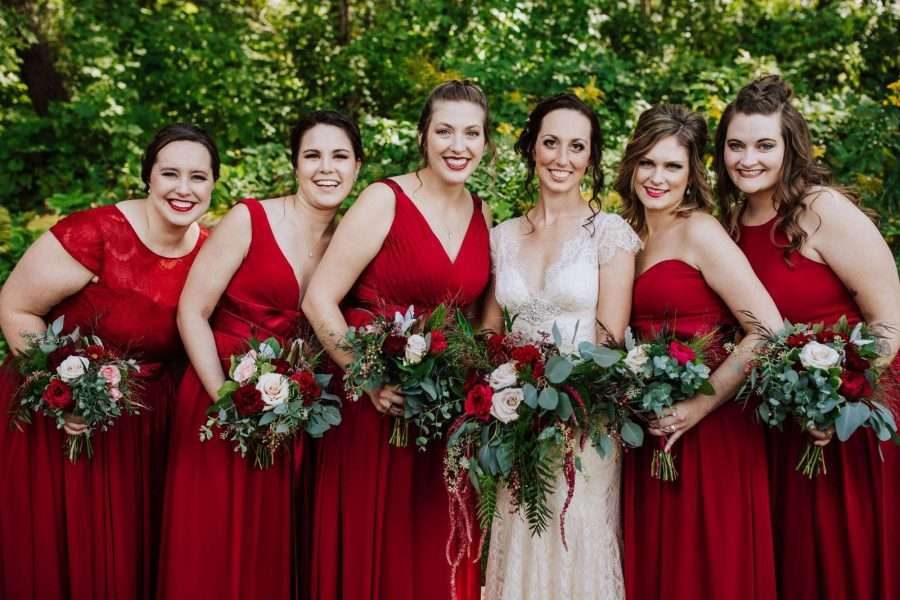 Bride and bridesmaids in red at Whistler's Knoll Vineyard Wedding.