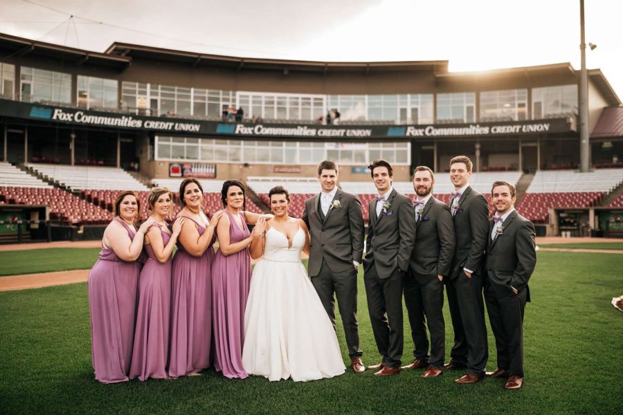 Wedding party poses at Fox Cities Stadium in Appleton, Wisconsin home of the Wisconsin Timber Rattlers.