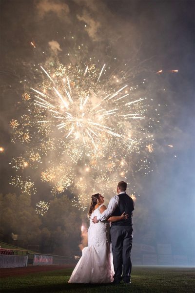 Bride and groom watch their fireworks at Fox Cities Stadium in Appleton, Wisconsin home of the Wisconsin Timber Rattlers.