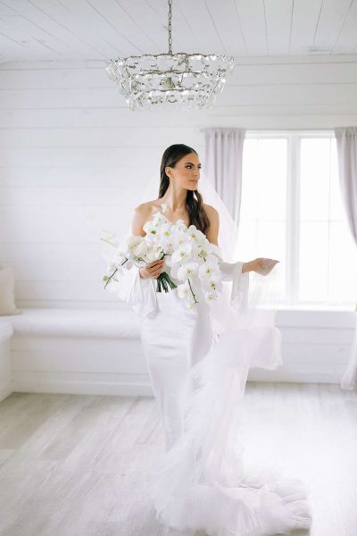Beautiful bride with white orchid bouquet.