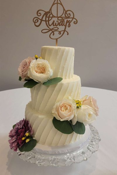 3 tiered white wedding cake with Always cake topper.