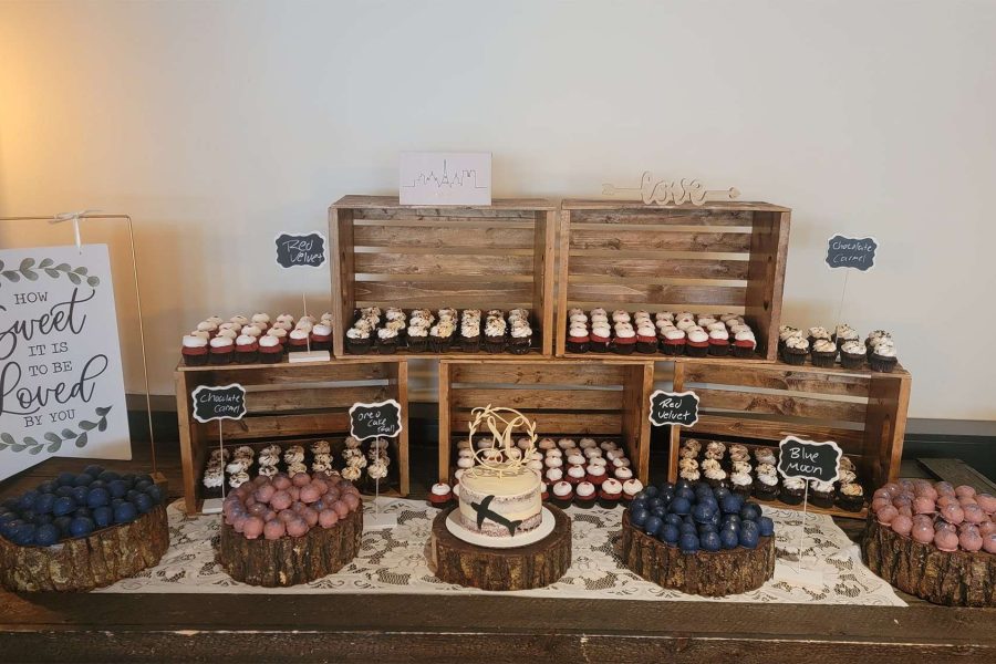 Rustic dessert table display with cupcakes, cake balls, and personal wedding cake.
